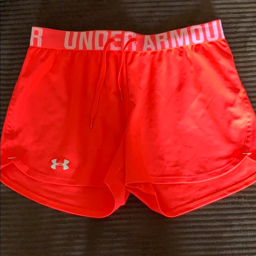Under Armour neon pink running shorts.
